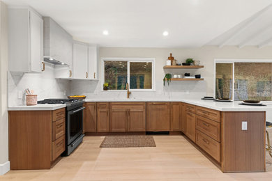 Inspiration for a mid-sized contemporary u-shaped vinyl floor and brown floor kitchen remodel in San Francisco with a single-bowl sink, shaker cabinets, medium tone wood cabinets, quartz countertops, white backsplash, quartz backsplash, stainless steel appliances and white countertops