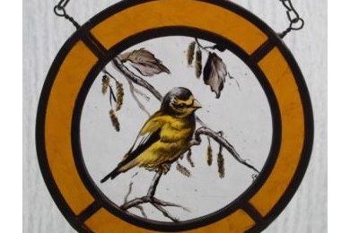 Bird designs of painted stained glass window hangings.