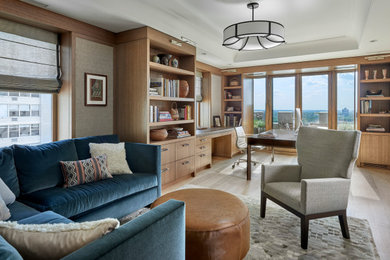 Example of a large transitional freestanding desk light wood floor, brown floor and wallpaper study room design in Chicago with beige walls