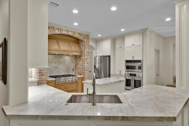 Inspiration for a mid-sized transitional u-shaped ceramic tile and beige floor eat-in kitchen remodel in Houston with an undermount sink, recessed-panel cabinets, beige cabinets, quartzite countertops, white backsplash, stainless steel appliances, an island and white countertops
