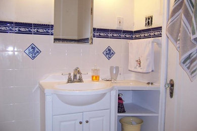 Mid-sized elegant 3/4 white tile and ceramic tile ceramic tile bathroom photo in Other with raised-panel cabinets, white cabinets, white walls, an integrated sink and solid surface countertops