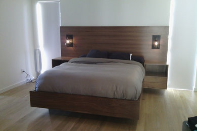 Inspiration for a large modern master medium tone wood floor bedroom remodel in Los Angeles