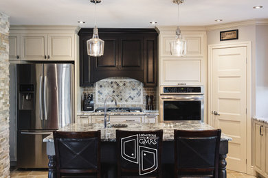 Inspiration for a large craftsman l-shaped ceramic tile and gray floor eat-in kitchen remodel in Montreal with an undermount sink, raised-panel cabinets, beige cabinets, granite countertops, red backsplash, ceramic backsplash, stainless steel appliances, an island and beige countertops