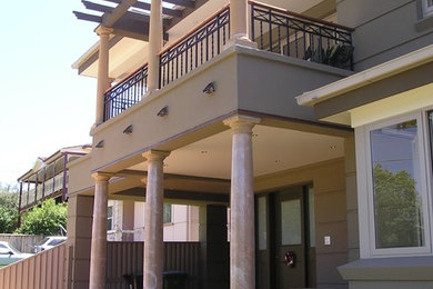 Photo of a contemporary two-storey beige exterior in Sydney.