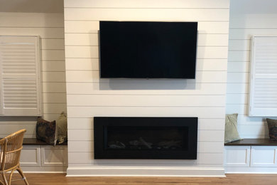 Large beach style open concept light wood floor family room photo in Philadelphia with white walls, a metal fireplace and a wall-mounted tv
