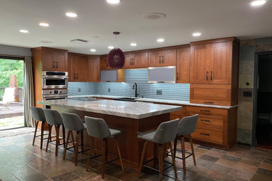 Large mountain style l-shaped slate floor and multicolored floor eat-in kitchen photo in Providence with a farmhouse sink, shaker cabinets, medium tone wood cabinets, quartzite countertops, gray backsplash, porcelain backsplash, stainless steel appliances, an island and gray countertops