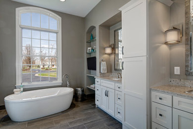 Bathroom - transitional master gray tile ceramic tile bathroom idea in Columbus with an undermount sink, white cabinets, quartz countertops, a one-piece toilet and gray walls