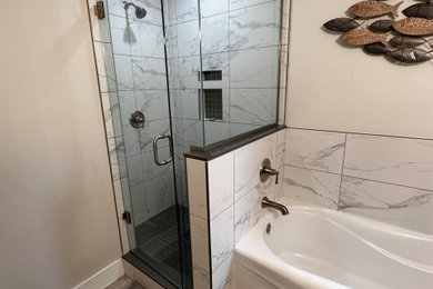 Mid-sized minimalist master gray tile and porcelain tile porcelain tile, gray floor and double-sink bathroom photo in Toronto with recessed-panel cabinets, gray cabinets, a two-piece toilet, gray walls, an undermount sink, marble countertops, a hinged shower door, yellow countertops, a niche and a freestanding vanity