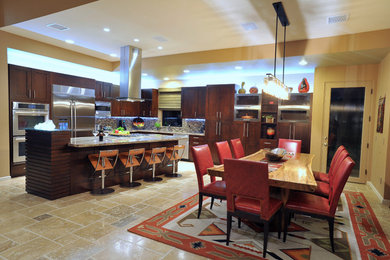 Trendy travertine floor kitchen photo in Other with an undermount sink, shaker cabinets, dark wood cabinets, granite countertops, multicolored backsplash, stainless steel appliances and an island