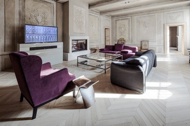 Large contemporary formal open concept living room in Milan with multi-coloured walls, light hardwood floors, a standard fireplace, a plaster fireplace surround and a freestanding tv.