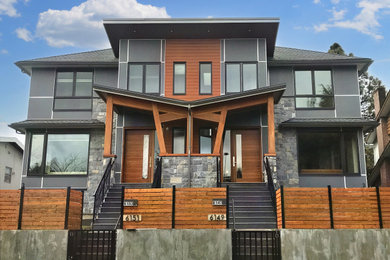 Example of a mid-sized two-story mixed siding and board and batten duplex exterior design in Vancouver