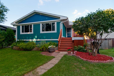 Mid-sized tropical multicolored two-story mixed siding exterior home idea in Minneapolis with a shingle roof