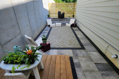 Example of a small minimalist backyard concrete paver patio design in Other