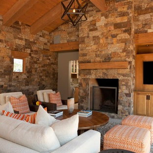 This is an example of a large rustic open plan home cinema in Albuquerque with a built-in media unit, multi-coloured walls and slate flooring.
