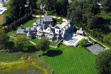 Huge traditional gray two-story stone gable roof idea in Bridgeport