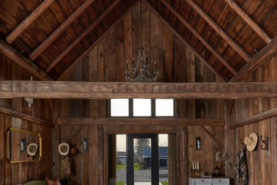 Example of a farmhouse concrete floor, gray floor, exposed beam, vaulted ceiling, wood ceiling and wood wall single front door design in Toronto with brown walls and a glass front door