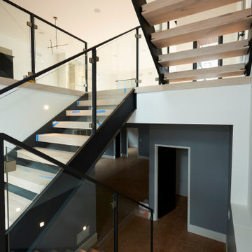 Open-Riser Floating Staircase with Glass Railings