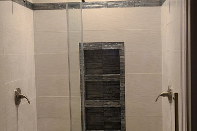 Imagen de cuarto de baño principal, doble y de pie actual grande con ducha doble, baldosas y/o azulejos de porcelana, encimera de granito, ducha con puerta corredera y hornacina