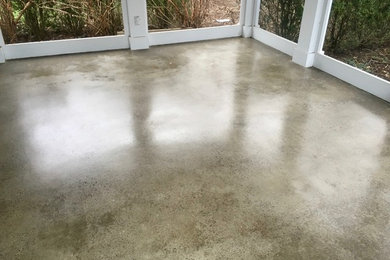 Mid-sized elegant stamped concrete screened-in back porch photo in Bridgeport with a roof extension