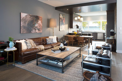 Inspiration for a mid-sized industrial open concept dark wood floor living room remodel in Calgary with gray walls, a tv stand, a standard fireplace and a tile fireplace