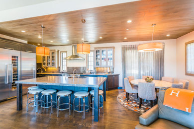 Large arts and crafts l-shaped dark wood floor and brown floor open concept kitchen photo in Denver with an undermount sink, recessed-panel cabinets, glass countertops, matchstick tile backsplash, stainless steel appliances, an island, gray backsplash and dark wood cabinets