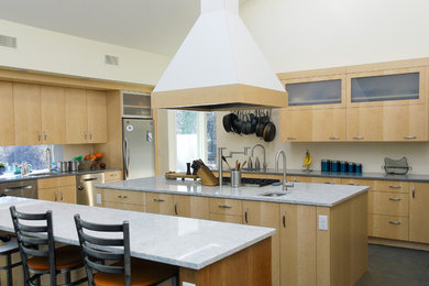 Example of a huge trendy u-shaped slate floor eat-in kitchen design in Boston with a single-bowl sink, flat-panel cabinets, yellow cabinets, quartz countertops, stainless steel appliances and two islands
