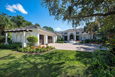 Example of a huge tuscan two-story concrete exterior home design in Other with a shingle roof