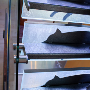 Glass private bar and glass stair treads inside a man cave in Michigan