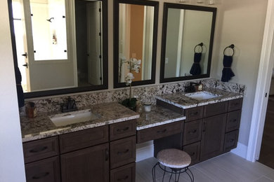Inspiration for a large timeless master porcelain tile bathroom remodel in Tampa with shaker cabinets, medium tone wood cabinets, a bidet, gray walls and granite countertops