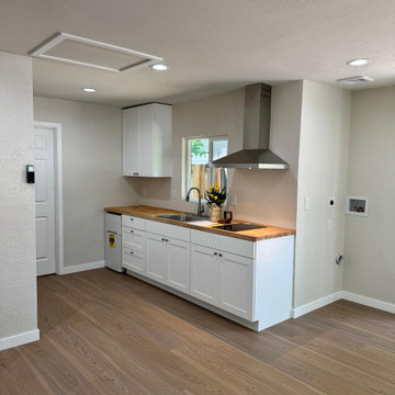 Compact Contemporary Kitchen with Butcher Block Countertops