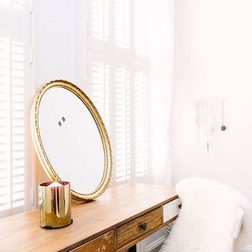 A rustic bedroom with a touch of blush and brass