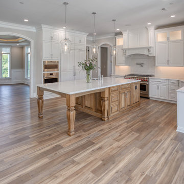 Transitional Kitchen with Two Toned Gathering Island & Archways