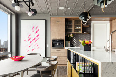 Photo of a large modern u-shaped kitchen in New York with flat-panel cabinets, medium wood cabinets, marble benchtops, with island and white benchtop.