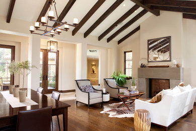 Large tuscan formal and open concept dark wood floor living room photo in San Francisco with beige walls, a standard fireplace, a stone fireplace and no tv