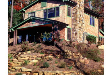 Example of an arts and crafts brown two-story wood exterior home design in Other