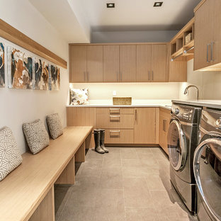 Contemporary l-shaped separated utility room in Denver with flat-panel cabinets, light wood cabinets, white walls and a side by side washer and dryer.