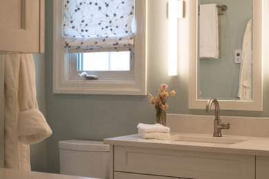 Example of a mid-sized transitional master white tile and stone slab porcelain tile, beige floor and double-sink bathroom design in Toronto with shaker cabinets, white cabinets, a one-piece toilet, blue walls, an undermount sink, quartz countertops, a hinged shower door, white countertops and a built-in vanity