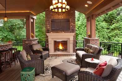 Patio kitchen - large traditional backyard patio kitchen idea in Seattle with a roof extension