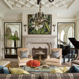 Inspiration for a mediterranean enclosed living room in Dallas with a music area, white walls, a standard fireplace, no tv and beige floors.