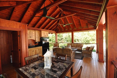 Inspiration for a large timeless backyard patio kitchen remodel in Other with an awning