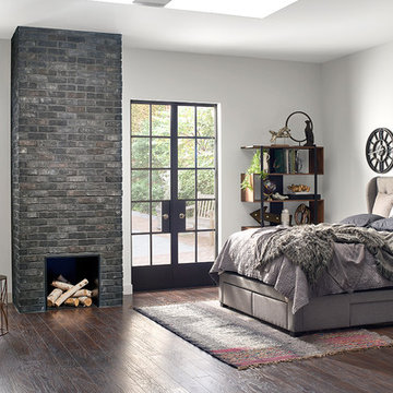 Moody and Modern Contemporary Bedroom With Dark Brick Fireplace