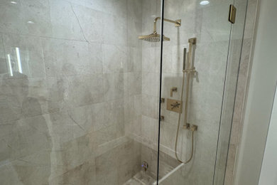 Large elegant master travertine tile travertine floor alcove shower photo in Atlanta with white walls, a hinged shower door and a built-in vanity