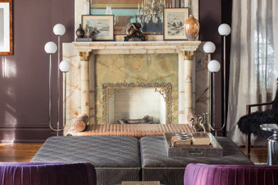 セントルイスにある高級な中くらいなエクレクティックスタイルのおしゃれなリビング (紫の壁、無垢フローリング、標準型暖炉、石材の暖炉まわり、茶色い床) の写真