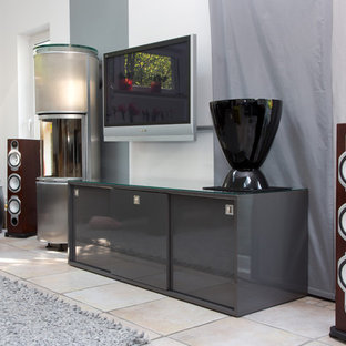 Mid-sized trendy home theater photo in Bremen with white walls and a projector screen