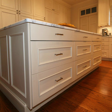 Wall of Pantry Cabinets and Island Storage Maximize Space in Woodmode Kitchen