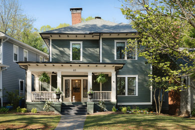 Example of a classic green two-story wood and clapboard house exterior design in Atlanta with a hip roof, a shingle roof and a gray roof