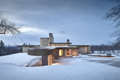 Inspiration for a large modern beige two-story house exterior remodel in Toronto