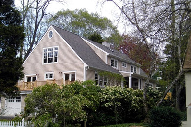 Mid-sized elegant beige two-story wood exterior home photo in New York with a shingle roof