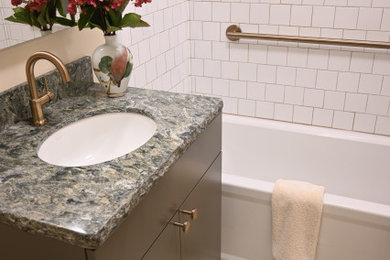 Example of a small ceramic tile, green floor and single-sink bathroom design in Grand Rapids with green cabinets, a one-piece toilet, yellow walls, an undermount sink, quartz countertops, green countertops and a built-in vanity