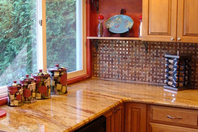 Mid-sized transitional u-shaped medium tone wood floor eat-in kitchen photo in New York with a drop-in sink, raised-panel cabinets, beige cabinets, granite countertops, multicolored backsplash, ceramic backsplash, black appliances and no island